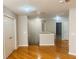 Second floor hallway with hardwood floors, three ceiling lights, and several doorways at 1963 White Top Rd., Lawrenceville, GA 30045