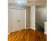 Upstairs hallway with wood flooring, double door closet, and access to the stairwell at 1963 White Top Rd., Lawrenceville, GA 30045