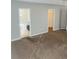 Open-concept living room with neutral walls and plush carpeting at 1963 White Top Rd., Lawrenceville, GA 30045