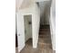 View of the carpeted stairs and open door to storage space under the stairs in the entryway at 1963 White Top Rd., Lawrenceville, GA 30045