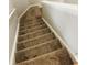 Carpeted staircase featuring neutral walls and white trim, providing access to multiple floors at 1963 White Top Rd. Se, Lawrenceville, GA 30045