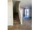 Carpeted staircase leading to the upper level of the home, offering a glimpse of the foyer at 1963 White Top Rd. Se, Lawrenceville, GA 30045