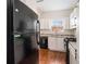 Kitchen boasts white cabinets, granite counters and black appliances at 277 Ralph David Abernathy Sw Blvd, Atlanta, GA 30312