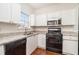 Kitchen with white cabinets, granite countertops, and black appliances at 277 Ralph David Abernathy Sw Blvd, Atlanta, GA 30312