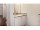 Small powder room with granite countertop and white cabinets at 277 Ralph David Abernathy Sw Blvd, Atlanta, GA 30312