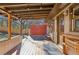 Covered back porch with wooden deck and red accent wall at 3001 Hilltop Dr, Atlanta, GA 30341