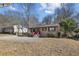 Tan house with red stairs and small front yard at 3001 Hilltop Dr, Atlanta, GA 30341