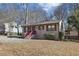 Tan house with red stairs and small front yard at 3001 Hilltop Dr, Atlanta, GA 30341