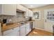 Galley kitchen with stainless steel appliances and tile backsplash at 3001 Hilltop Dr, Atlanta, GA 30341