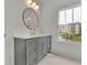 Bathroom featuring a framed mirror, undermount sink and great natural light at 350 Sugarview Rd, Sugar Hill, GA 30518