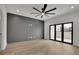 Spacious bedroom features modern ceiling fan and doors leading to private balcony at 350 Sugarview Rd, Sugar Hill, GA 30518