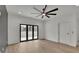 Bright bedroom with hardwood floors, a ceiling fan, and access to a private balcony at 350 Sugarview Rd, Sugar Hill, GA 30518