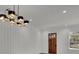 Bright entryway with wood floors and modern chandelier at 350 Sugarview Rd, Sugar Hill, GA 30518