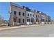 Row of new townhouses with brick and white exteriors at 350 Sugarview Rd, Sugar Hill, GA 30518