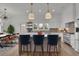 Bright, white kitchen with a large island, pendant lighting, and seating for casual dining at 350 Sugarview Rd, Sugar Hill, GA 30518