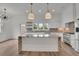 Bright, white kitchen with a large island, pendant lighting, and stainless steel appliances for a modern feel at 350 Sugarview Rd, Sugar Hill, GA 30518