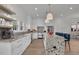 Modern kitchen with white cabinets, granite island and breakfast bar at 350 Sugarview Rd, Sugar Hill, GA 30518