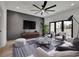 Modern living room with hardwood floors, a gray accent wall, and plenty of natural light at 350 Sugarview Rd, Sugar Hill, GA 30518