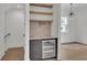 Stylish wet bar with wine cooler, granite countertop, and wooden shelving at 350 Sugarview Rd, Sugar Hill, GA 30518