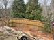 Landscaped backyard with wooden fence and rock retaining wall at 4338 Braden Nw Ln, Kennesaw, GA 30144