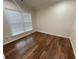 Simple bedroom with hardwood floors and a large window at 4338 Braden Nw Ln, Kennesaw, GA 30144