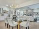 Open dining room with glass table and modern chandelier at 754 Moon Rd, Lawrenceville, GA 30046