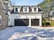 Three-car garage with black doors and concrete driveway at 754 Moon Road, Lawrenceville, GA 30046