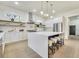 Modern kitchen with white cabinets, marble countertops, and breakfast bar at 754 Moon Road, Lawrenceville, GA 30046