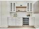 Butler's pantry with white shaker cabinets, quartz countertops and wine refrigerator at 754 Moon Road, Lawrenceville, GA 30046