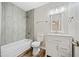 Updated bathroom features a white vanity, gray tile shower, and updated fixtures at 1546 Richland Sw Rd, Atlanta, GA 30311