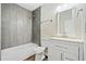 Updated bathroom features a white vanity, gray tile shower, and updated fixtures at 1546 Richland Sw Rd, Atlanta, GA 30311