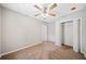 Bedroom with ceiling fan, carpet, and double-door closet at 1546 Richland Sw Rd, Atlanta, GA 30311