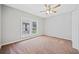 Bright bedroom with ceiling fan, carpet, and large windows at 1546 Richland Sw Rd, Atlanta, GA 30311