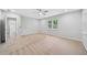 Bright bedroom with neutral carpeting and ceiling fan, access to other rooms at 1546 Richland Sw Rd, Atlanta, GA 30311