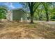 Green house exterior with a side view and mature trees at 1546 Richland Sw Rd, Atlanta, GA 30311