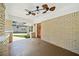 Inviting front porch with ceiling fan, brick floors, and a wooden door at 1546 Richland Sw Rd, Atlanta, GA 30311
