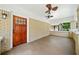 Spacious front porch with ceiling fan and wooden front door at 1546 Richland Sw Rd, Atlanta, GA 30311