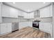 Modern kitchen with white cabinets, granite counters, and stainless steel appliances at 1546 Richland Sw Rd, Atlanta, GA 30311