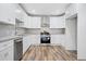 Modern kitchen with white cabinets, granite counters, and stainless steel appliances at 1546 Richland Sw Rd, Atlanta, GA 30311