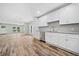 Modern kitchen with white cabinets, granite counters, and stainless steel appliances at 1546 Richland Sw Rd, Atlanta, GA 30311