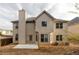 The exterior back of this house has a chimney, porch, and ample windows for a well lit interior at 3535 Clarecastle Dr, Buford, GA 30519