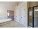 Bathroom leading to bedroom with tiled floor, white doors, and glass shower at 3535 Clarecastle Dr, Buford, GA 30519