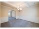 Spacious dining room featuring wainscoting, a modern chandelier, and a coffered ceiling at 3535 Clarecastle Dr, Buford, GA 30519