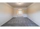 Dining room with gray carpet and white wainscoting and access to another room at 3535 Clarecastle Dr, Buford, GA 30519
