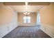 Dining room with modern chandelier, white trim and gray carpeting at 3535 Clarecastle Dr, Buford, GA 30519