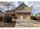 Two-story home with brick and vinyl siding, plus a two-car garage and driveway at 3535 Clarecastle Dr, Buford, GA 30519