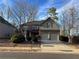 Brick two-story house with a three-car garage and landscaped yard at 3535 Clarecastle Dr, Buford, GA 30519