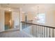 Upstairs hallway boasting wrought iron banister and decorative lighting at 3535 Clarecastle Dr, Buford, GA 30519