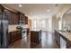 Well-lit kitchen boasting dark wood cabinets, stainless steel appliances, and a granite countertop island at 3535 Clarecastle Dr, Buford, GA 30519