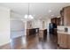 Bright kitchen featuring dark wood cabinets, stainless steel appliances, hardwood floors, and granite countertops at 3535 Clarecastle Dr, Buford, GA 30519